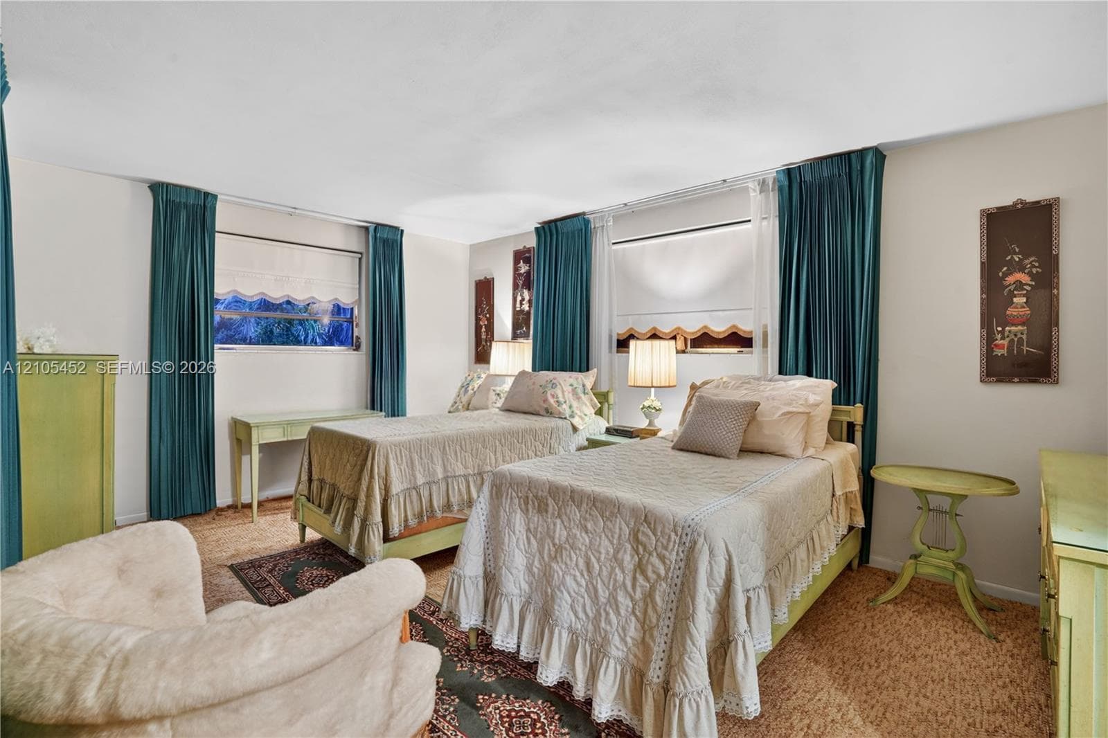 Spacious room featuring neutral wall tones, two large dual-panel windows, and floor-to-ceiling drapery