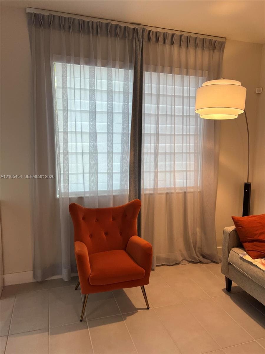 Dual windows with sheer privacy shades and full-length drapery