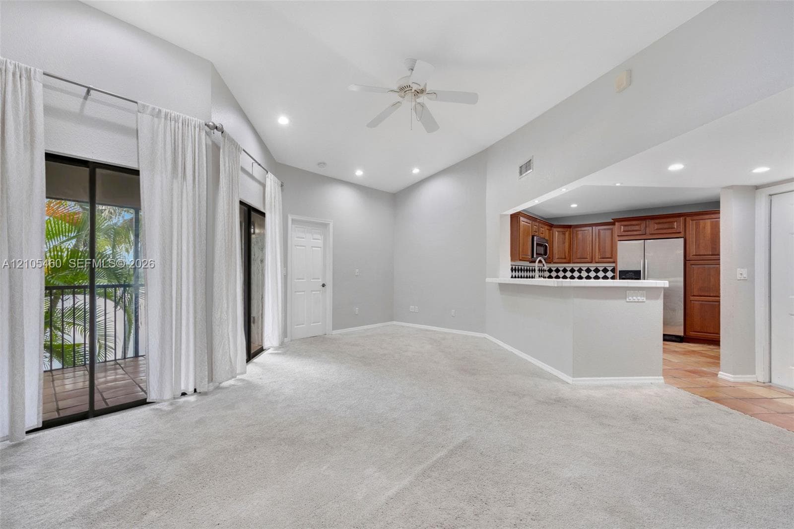 Vaulted ceilings, recessed lighting, and a ceiling fan