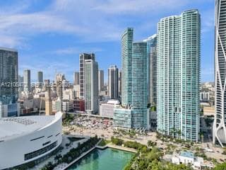 Expansive cityscape featuring modern high-rise architecture and a prominent waterfront