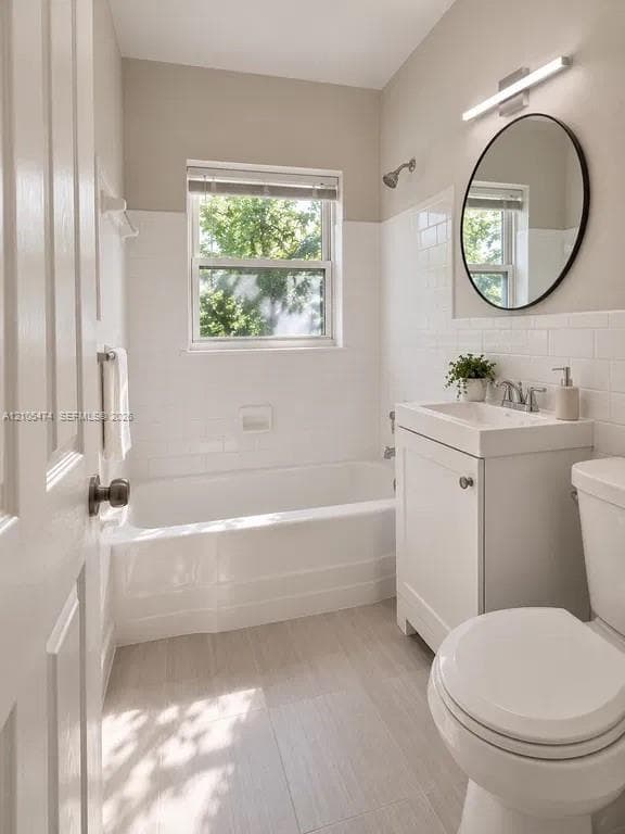 Bathroom featuring a white subway tile surround, neutral wall paint, and light-toned tile flooring