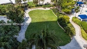 Expansive central lawn featuring perimeter walkways, mature landscaping, and integrated outdoor recreational areas