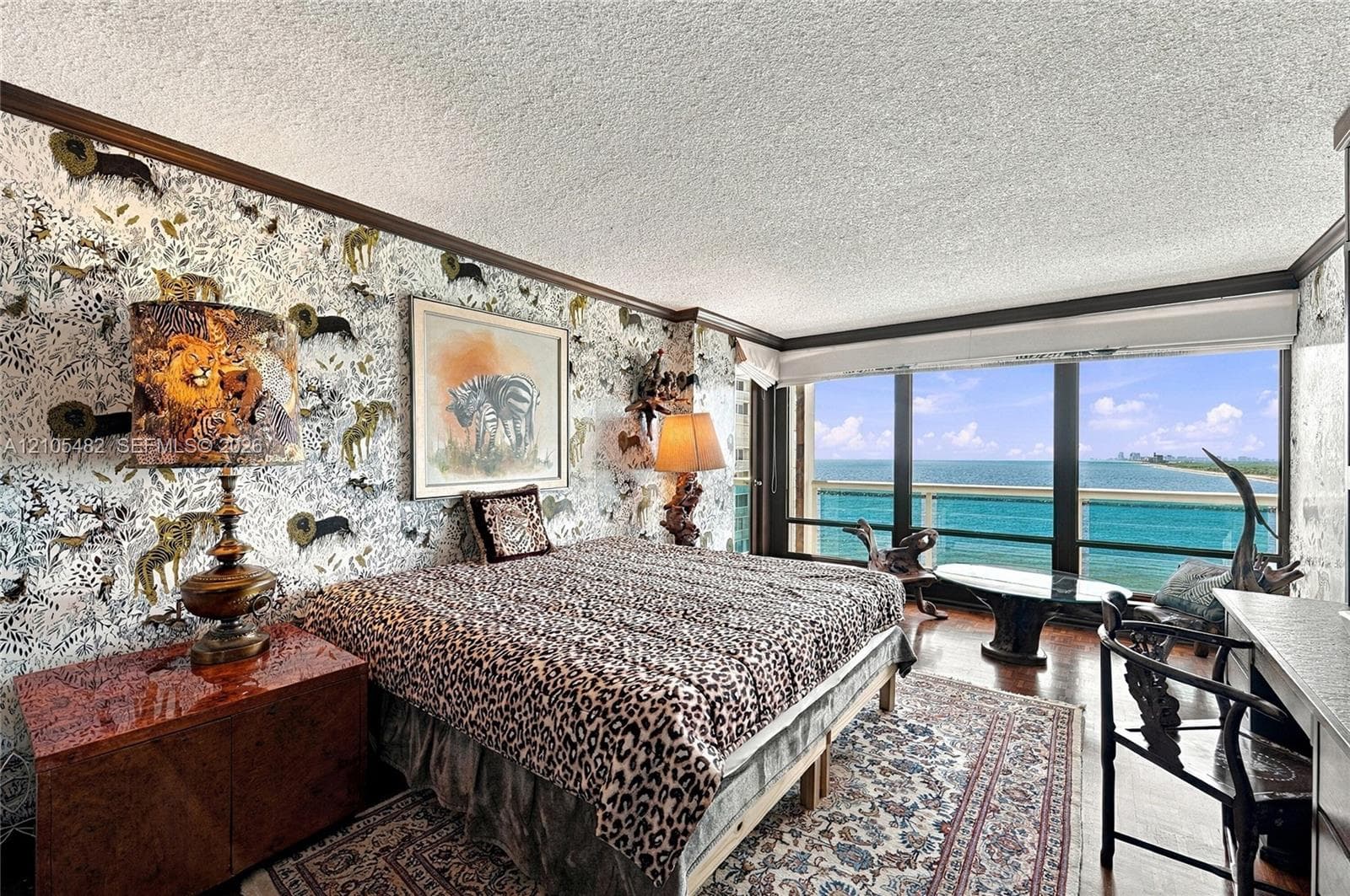 Expansive floor-to-ceiling windows, private balcony, wood-finish flooring, and crown molding