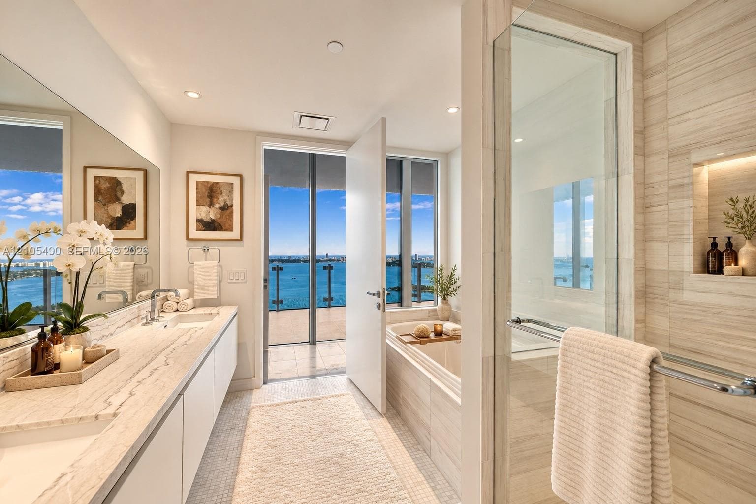 Bathroom featuring a dual-sink vanity with stone countertop, soaking tub, glass-enclosed walk-in shower with tiled surround, and integrated recessed shelving