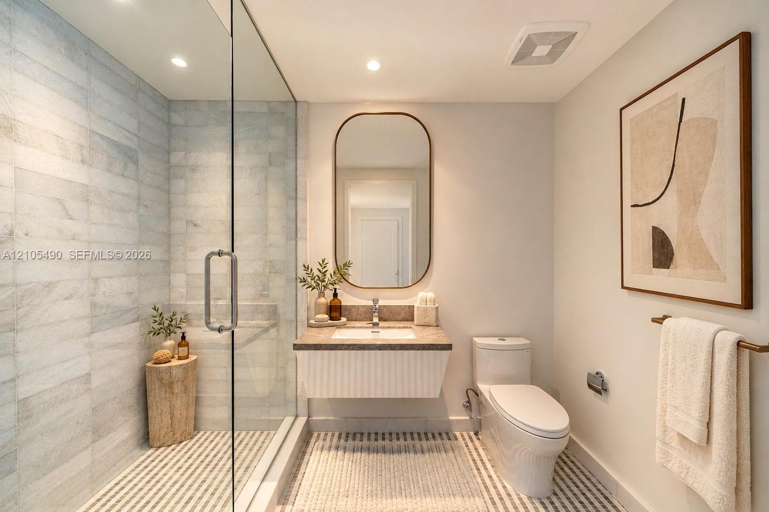 Glass-enclosed shower with horizontal wall tile, floating vanity with a stone countertop, integrated sink, and an arched wall mirror