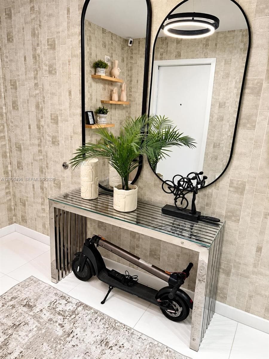 Textured neutral-toned wallpaper, dual floor-to-ceiling arched mirrors with black metal framing, built-in wooden wall shelving, and polished tile flooring