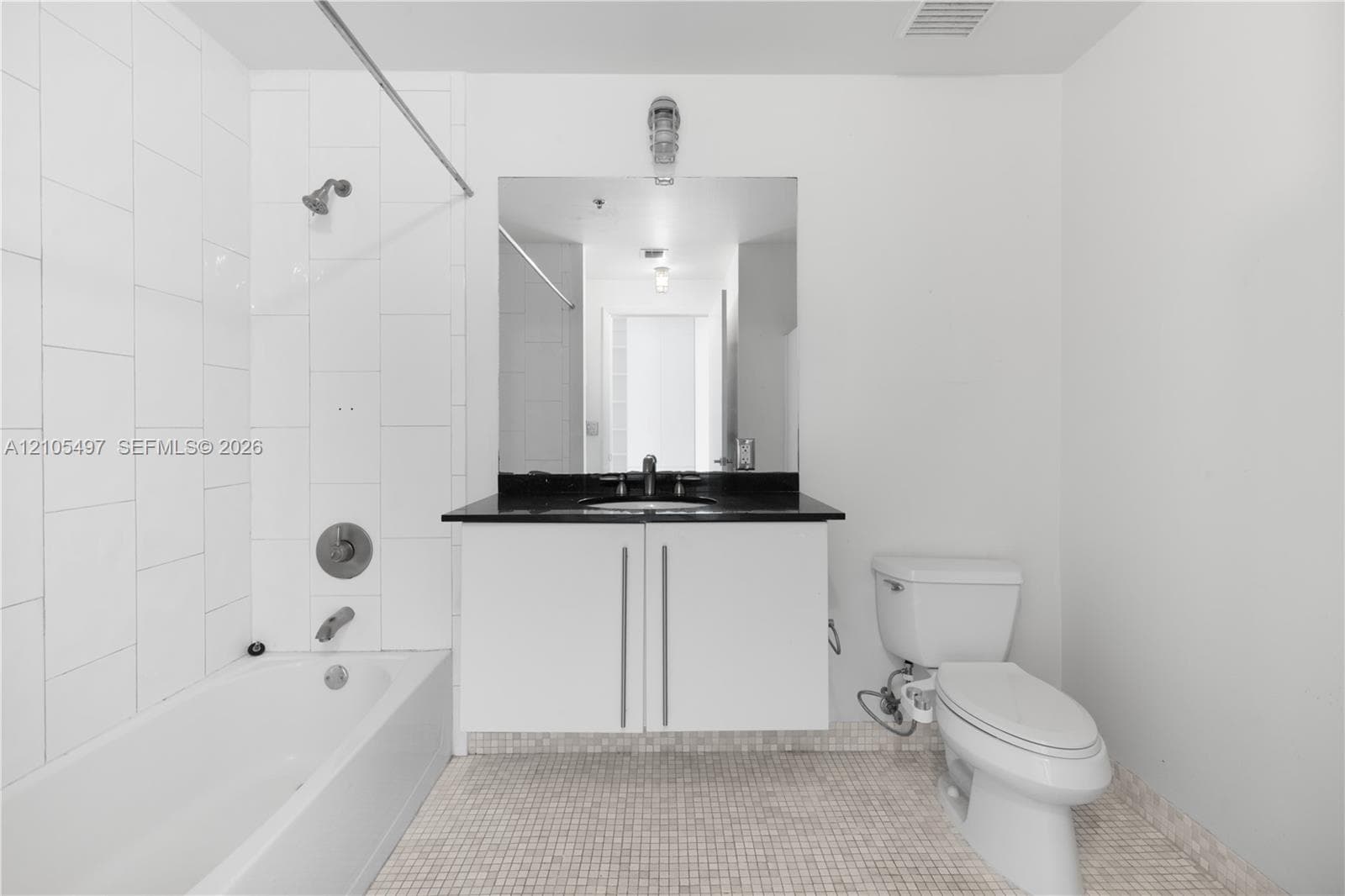 White subway-tiled shower surround with a built-in bathtub