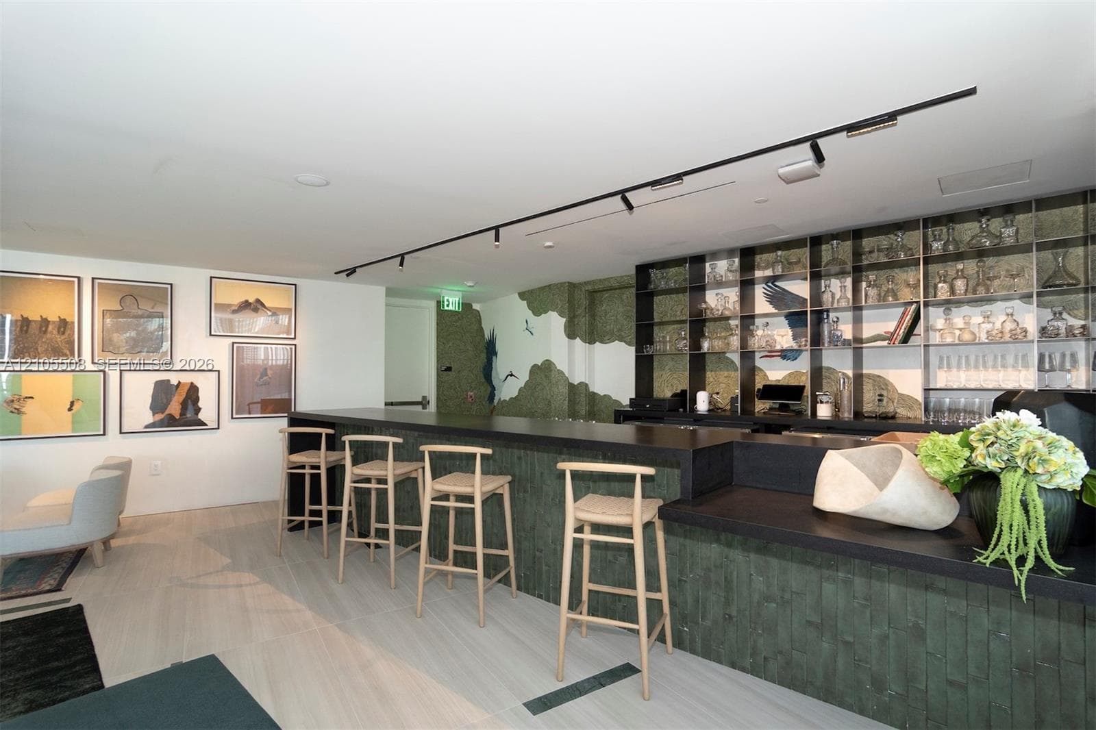 Bar area featuring a dark countertop, integrated shelving with glass accents, and wood-finish flooring