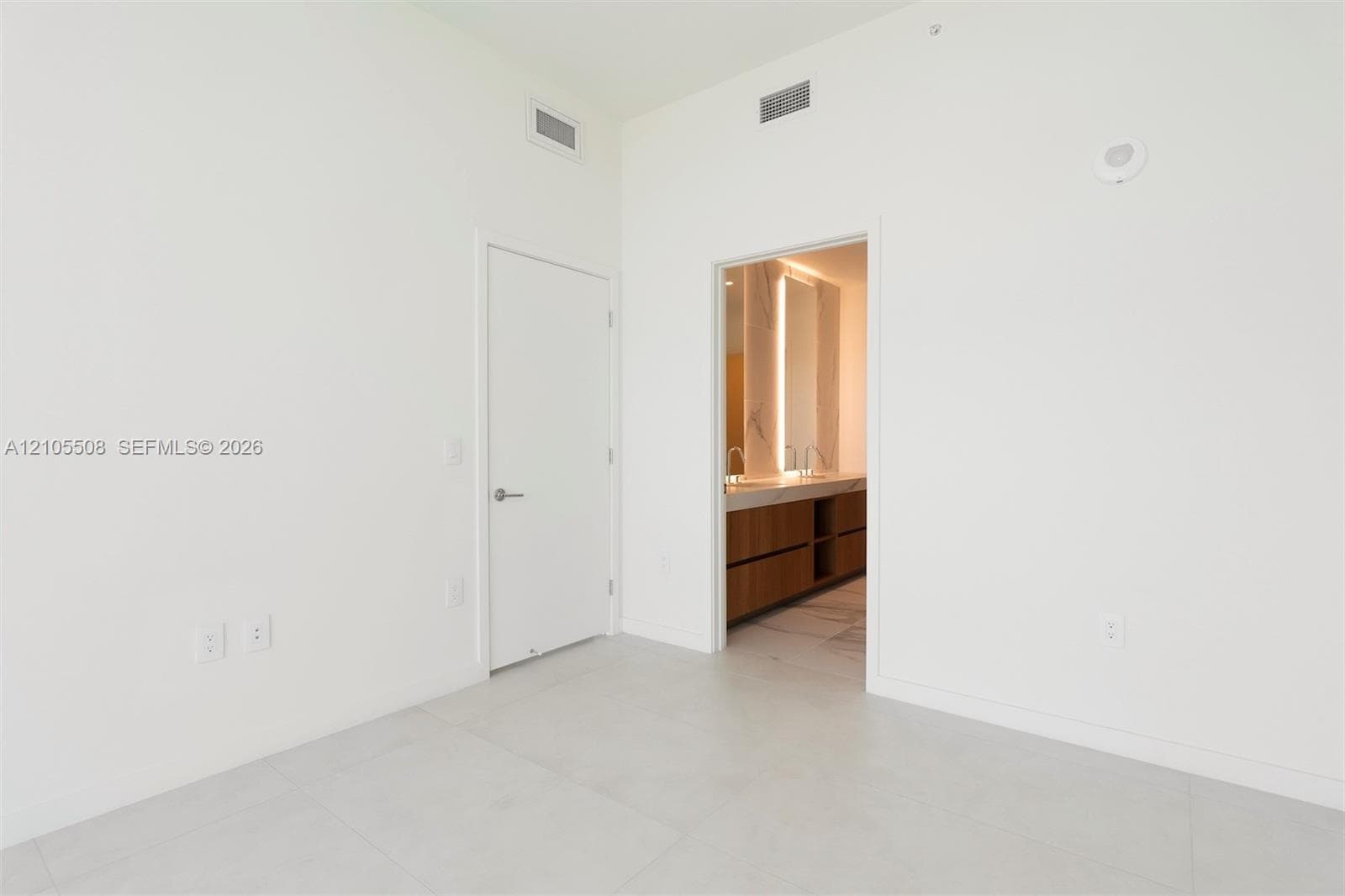 Tile flooring, recessed lighting, and a neutral color palette