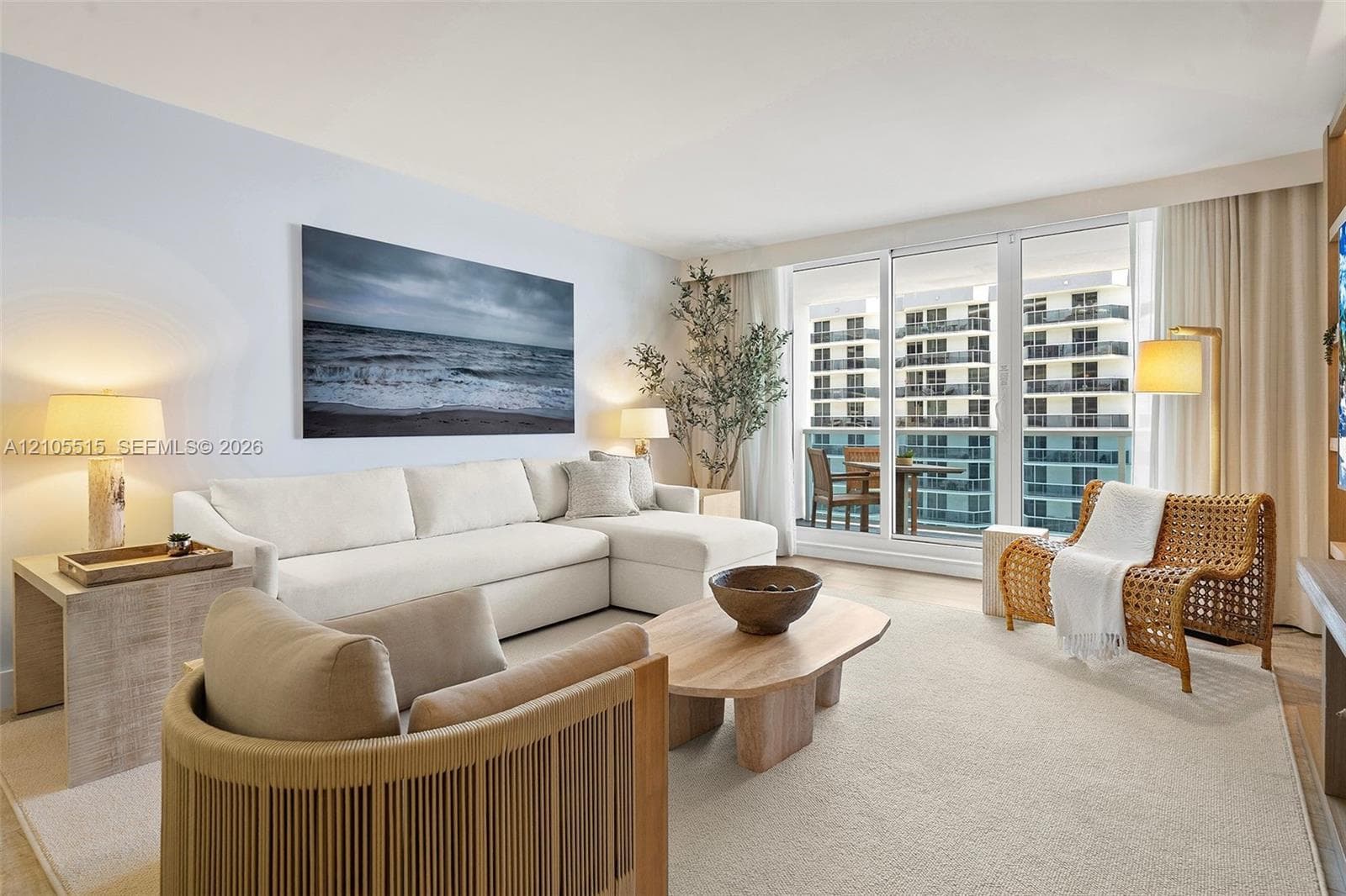 Living space featuring floor-to-ceiling glass sliding doors, private balcony access, and light-toned flooring