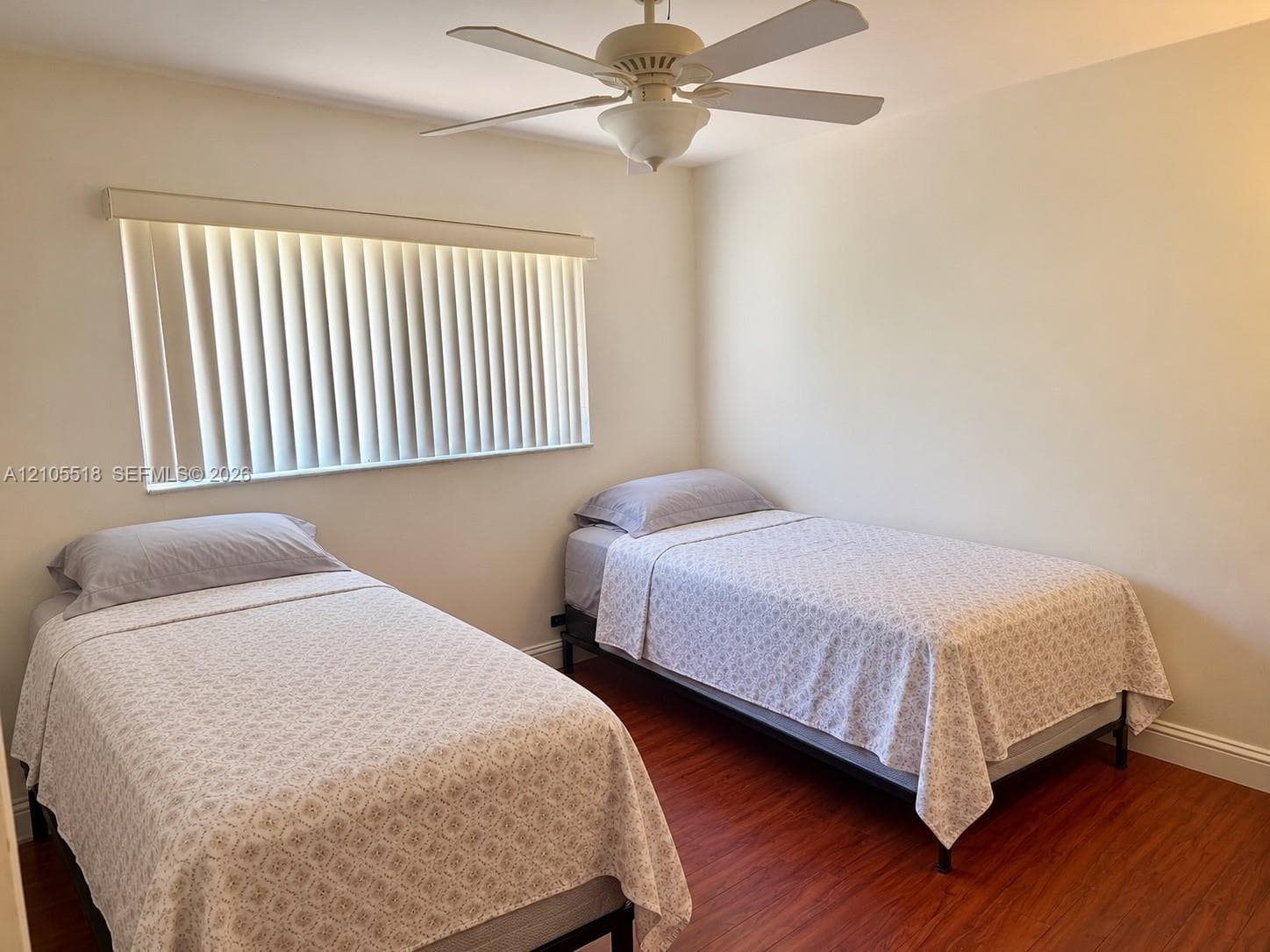 Wood-finish flooring, ceiling fan with integrated light fixture, and horizontal blind window treatment