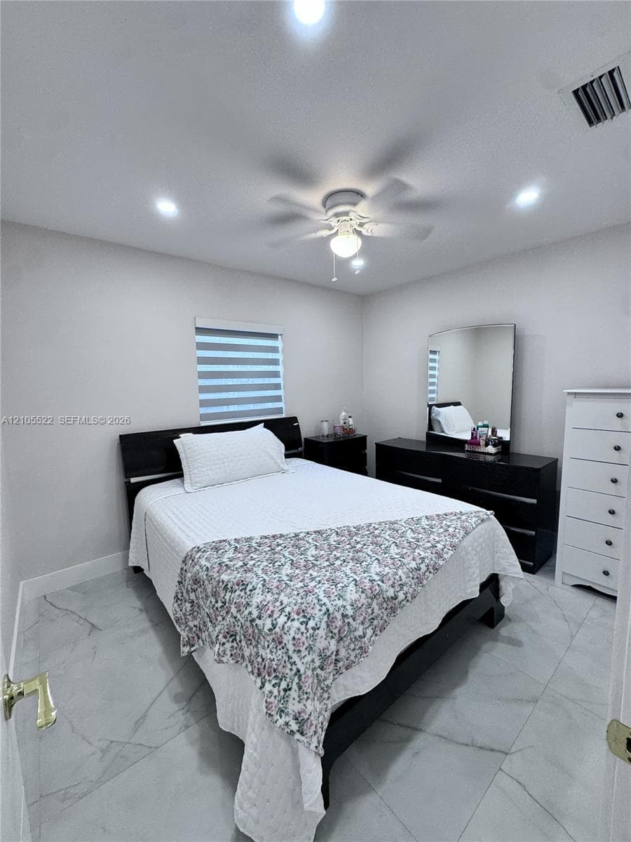 Recessed lighting, ceiling fan, window with horizontal blinds, and large format tile flooring