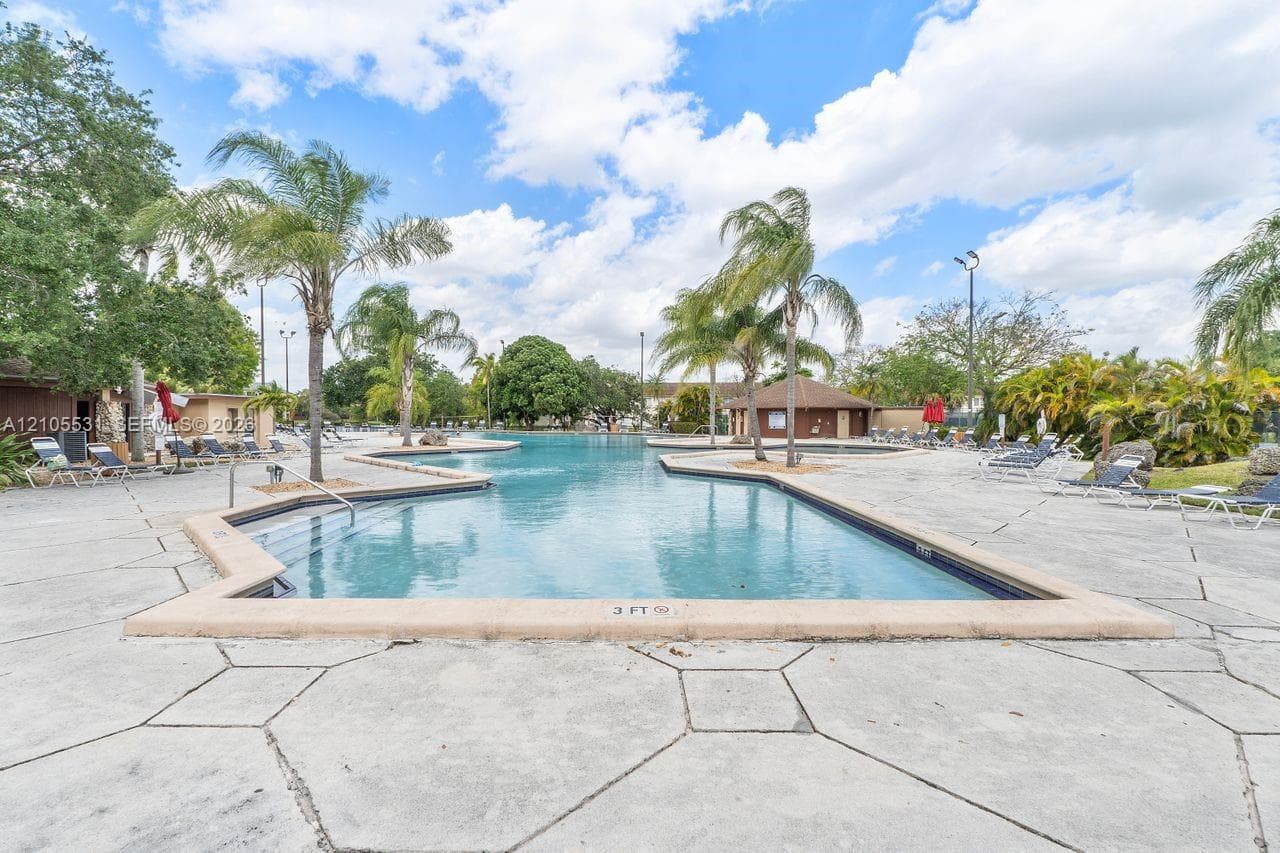 Expansive, free-form swimming pool with integrated spa