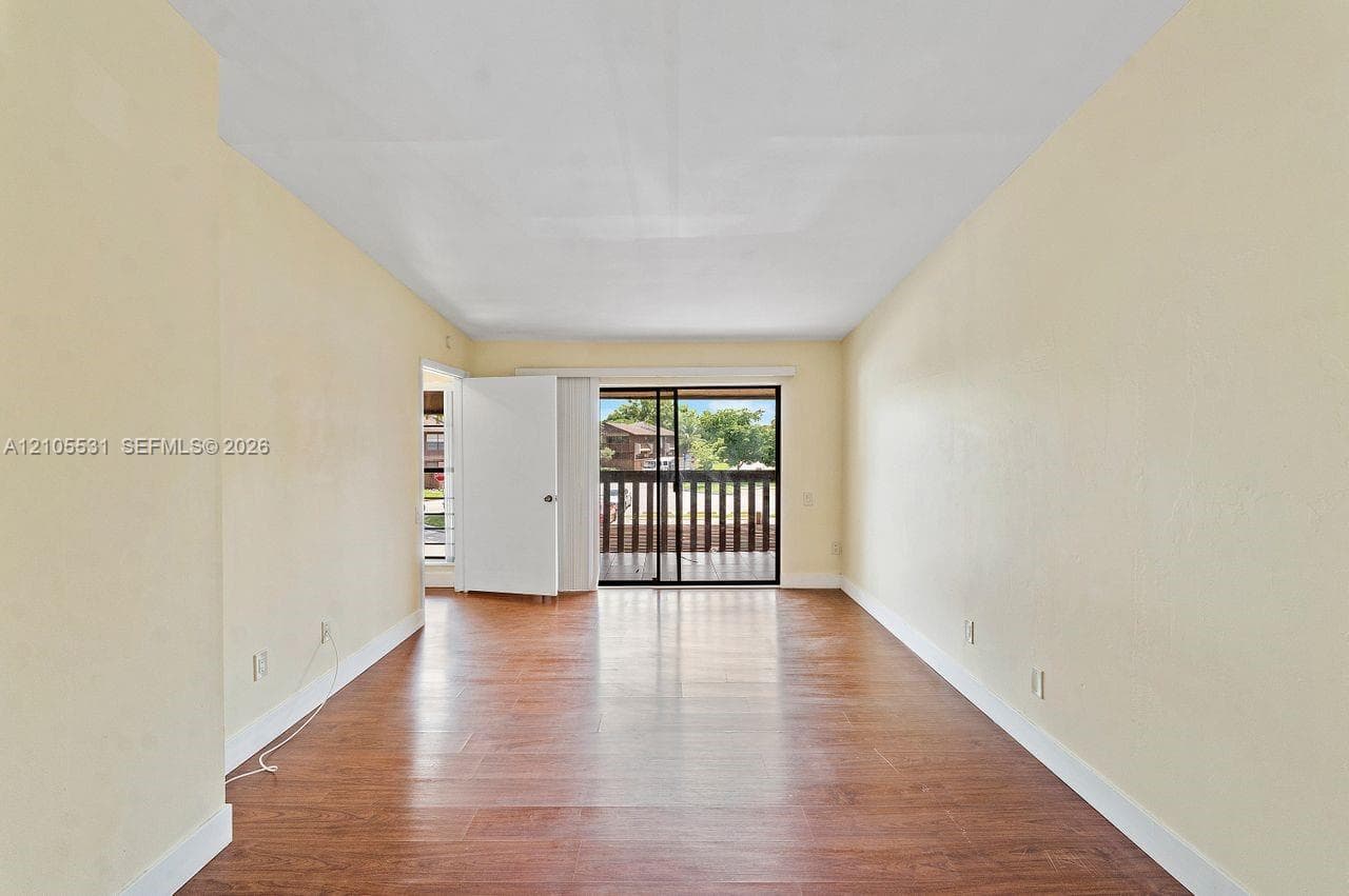 Wood-finish flooring throughout, complemented by light-toned wall finishes and white trim