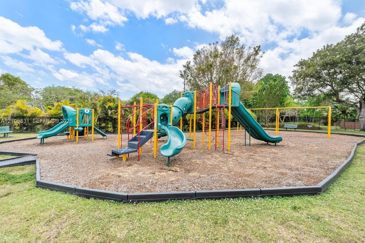 Dedicated playground area featuring multiple slides, climbing structures, and swings