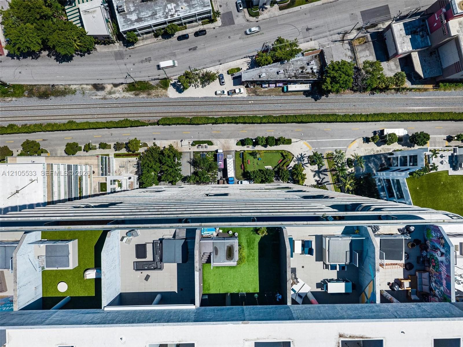 High-rise terrace featuring concrete dividers, synthetic grass surfacing, and private outdoor space