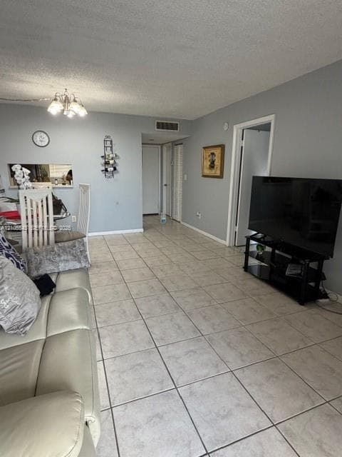 Neutral-toned ceramic tile flooring, multi-arm ceiling-mounted light fixture, and interior pass-through window with shelf