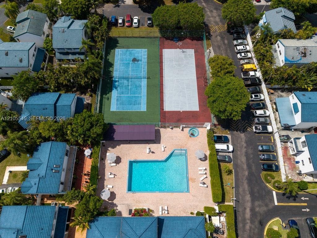 Community amenities featuring a tennis court, basketball court, swimming pool, and dedicated parking areas