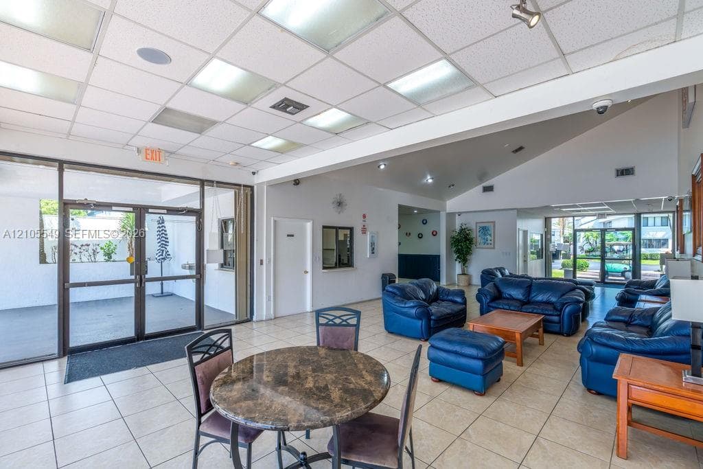 Tile flooring throughout with a vaulted ceiling and recessed lighting