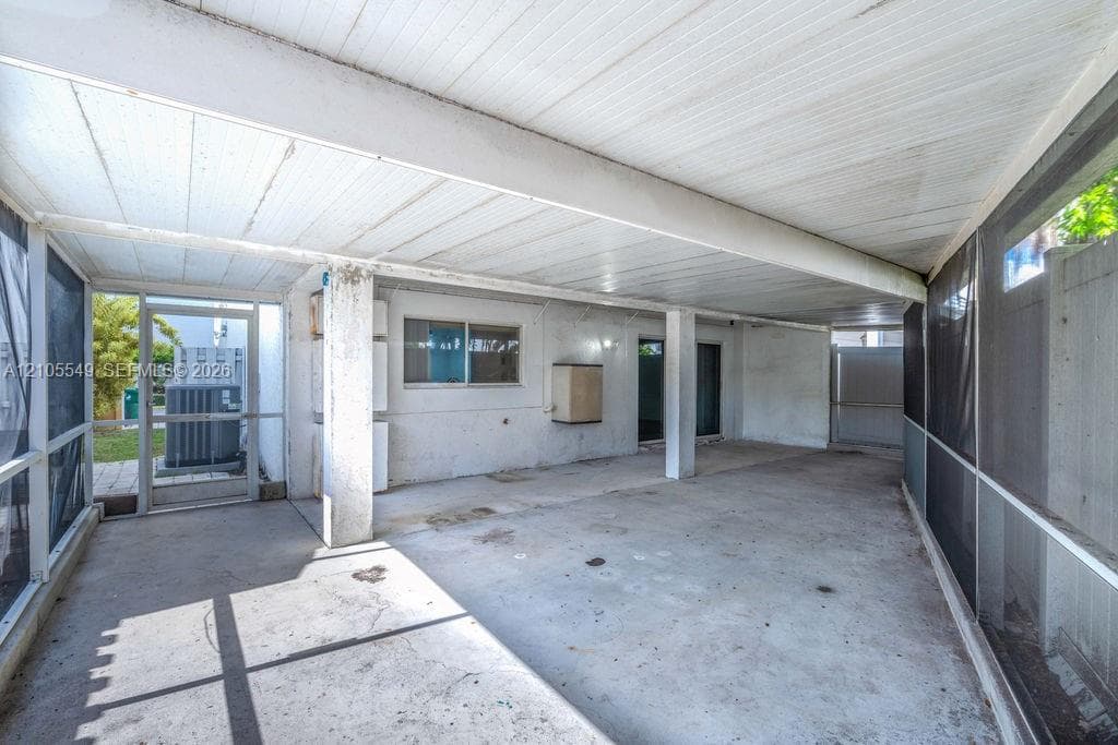 Screened patio with a concrete floor and a solid roof