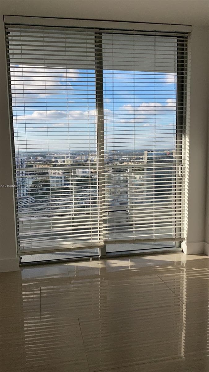 Large sliding glass door with white horizontal blinds