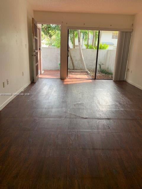 Wood-finish flooring throughout, sliding glass door leading to a private outdoor space, and an additional exterior door providing direct access