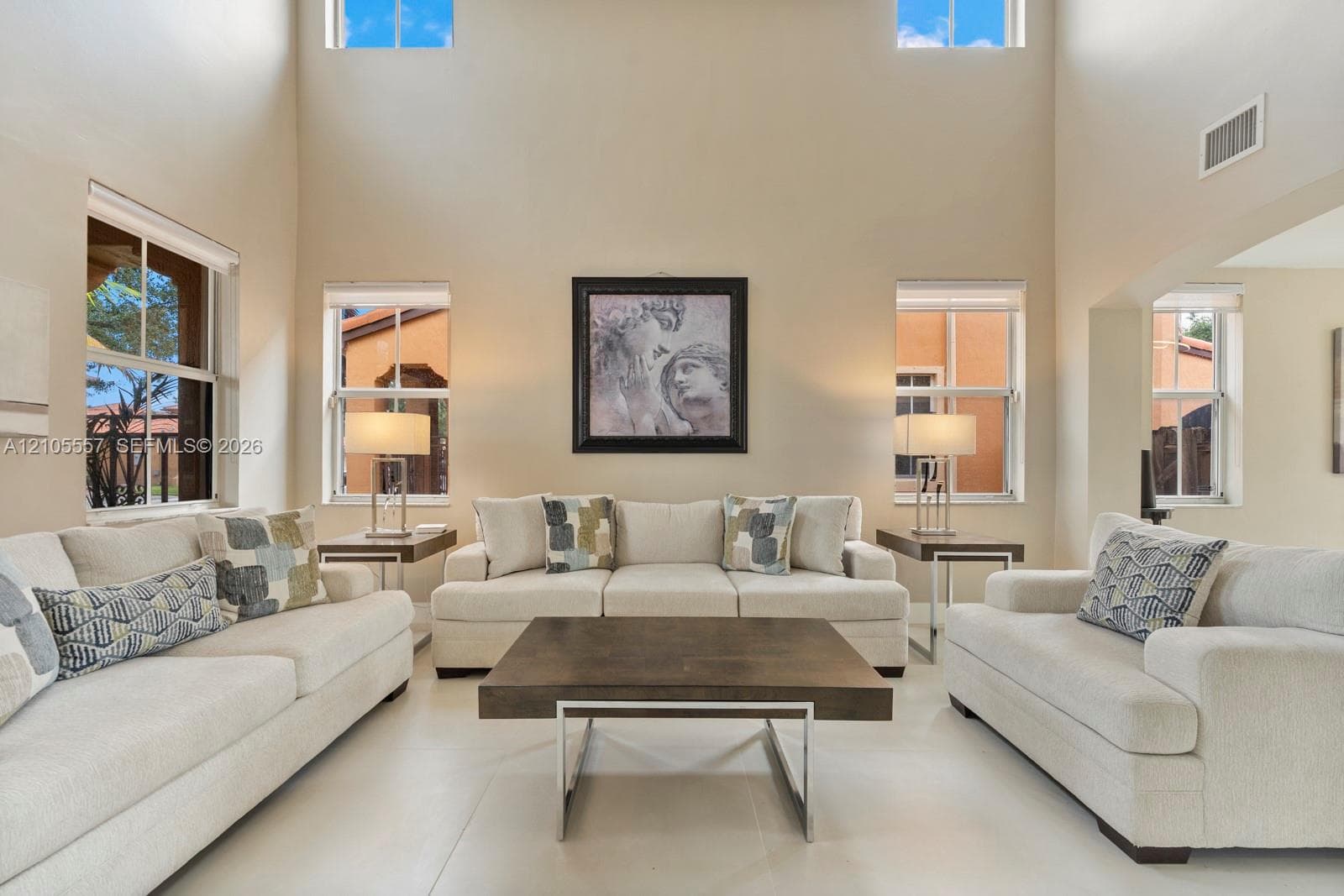 Vaulted ceilings, multiple windows, and light-colored walls create an open atmosphere
