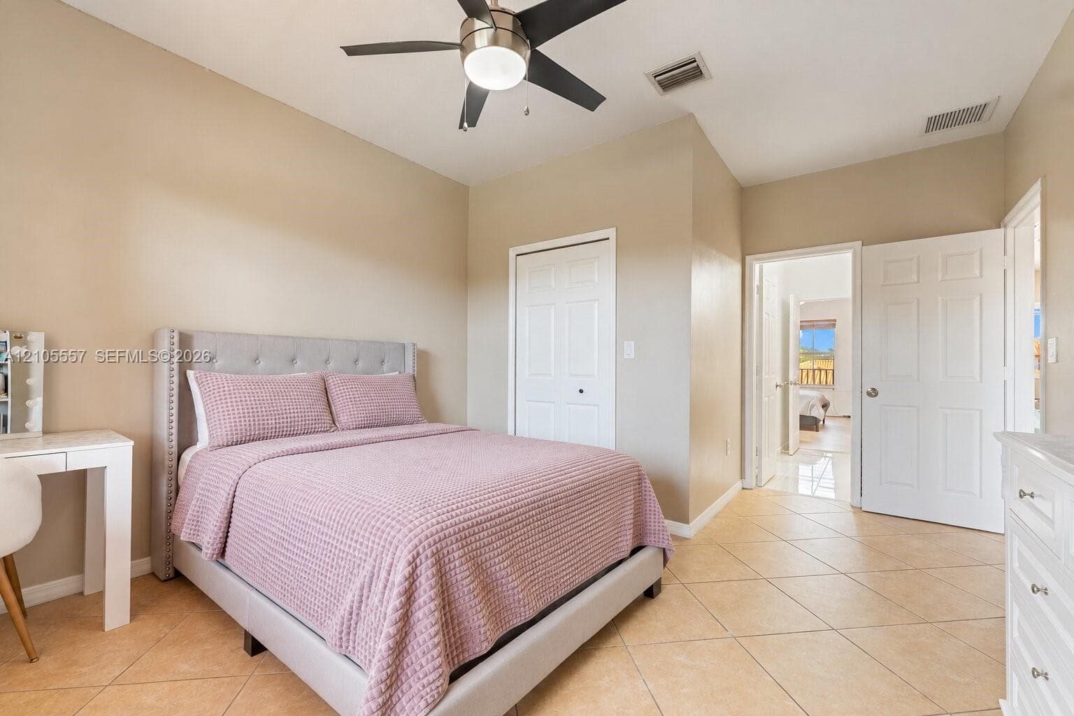 Recessed lighting in ceiling fan, light neutral wall paint, tiled flooring, white bi-fold closet doors, and white interior doors