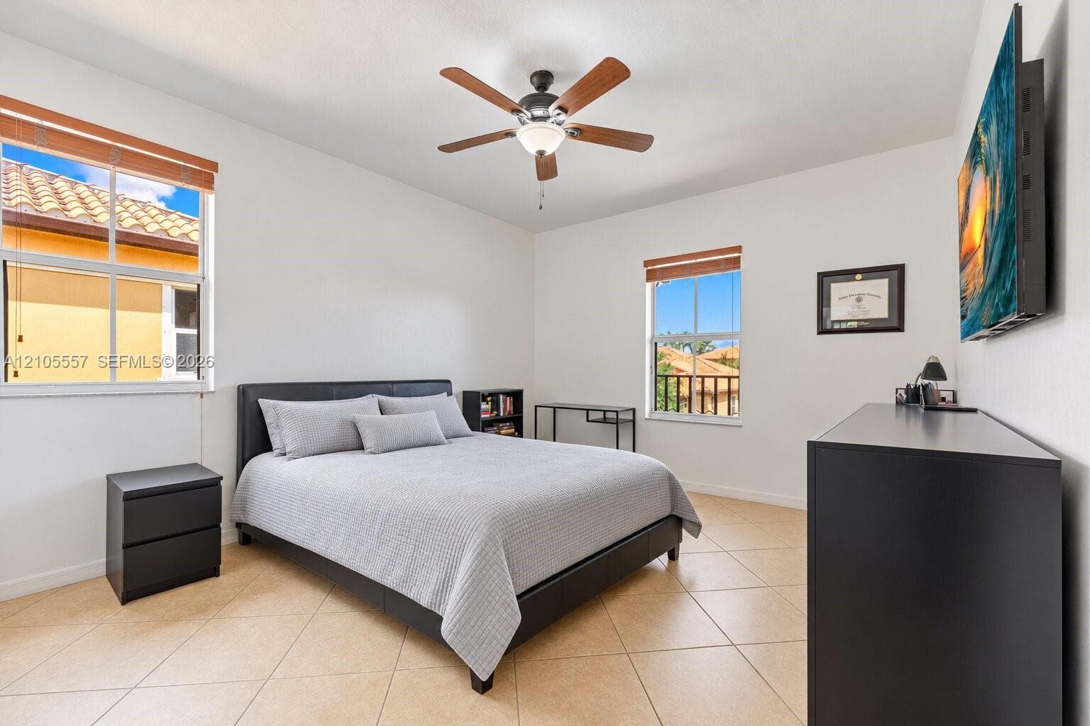 Tiled flooring, white walls, and a ceiling fan with integrated lighting