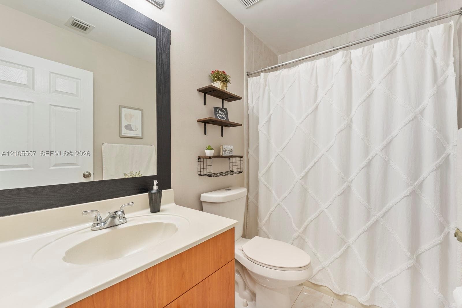 Integrated vanity with a single basin sink and a wood-finish cabinet