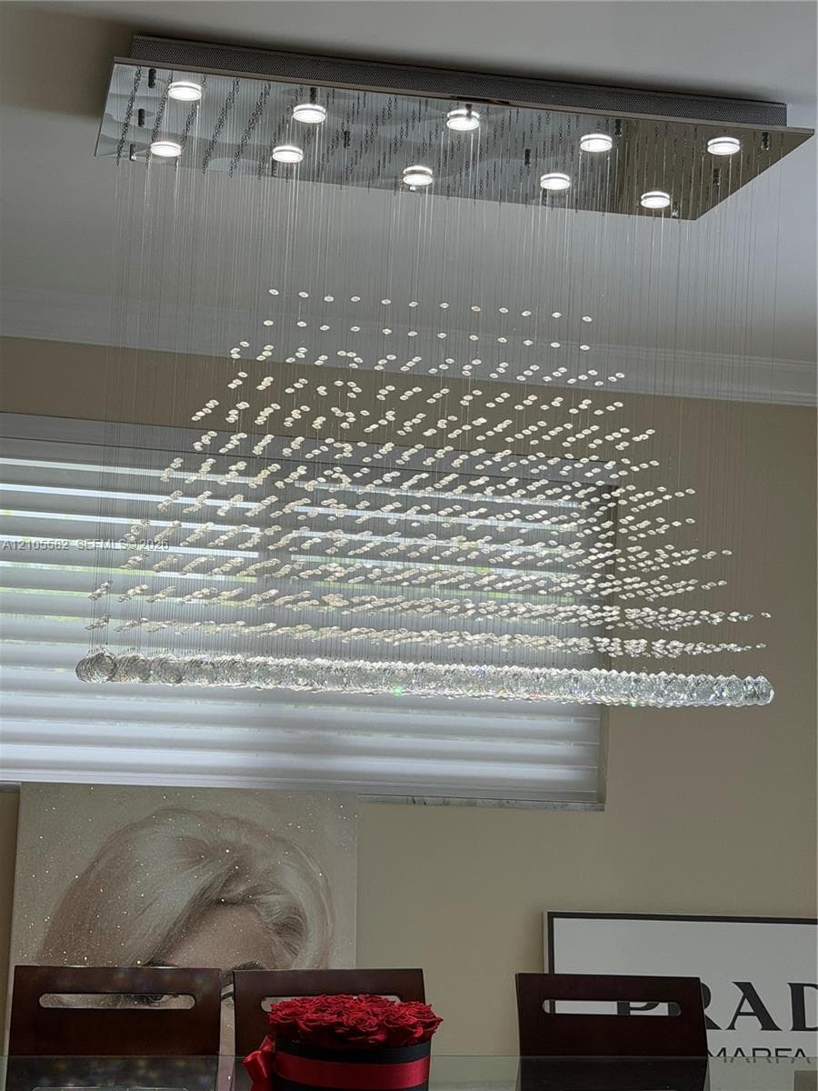Rectangular chrome ceiling light fixture with multiple integrated downlights and cascading crystal elements