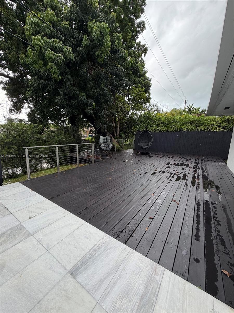 Expansive outdoor deck with dark wood-finish planking