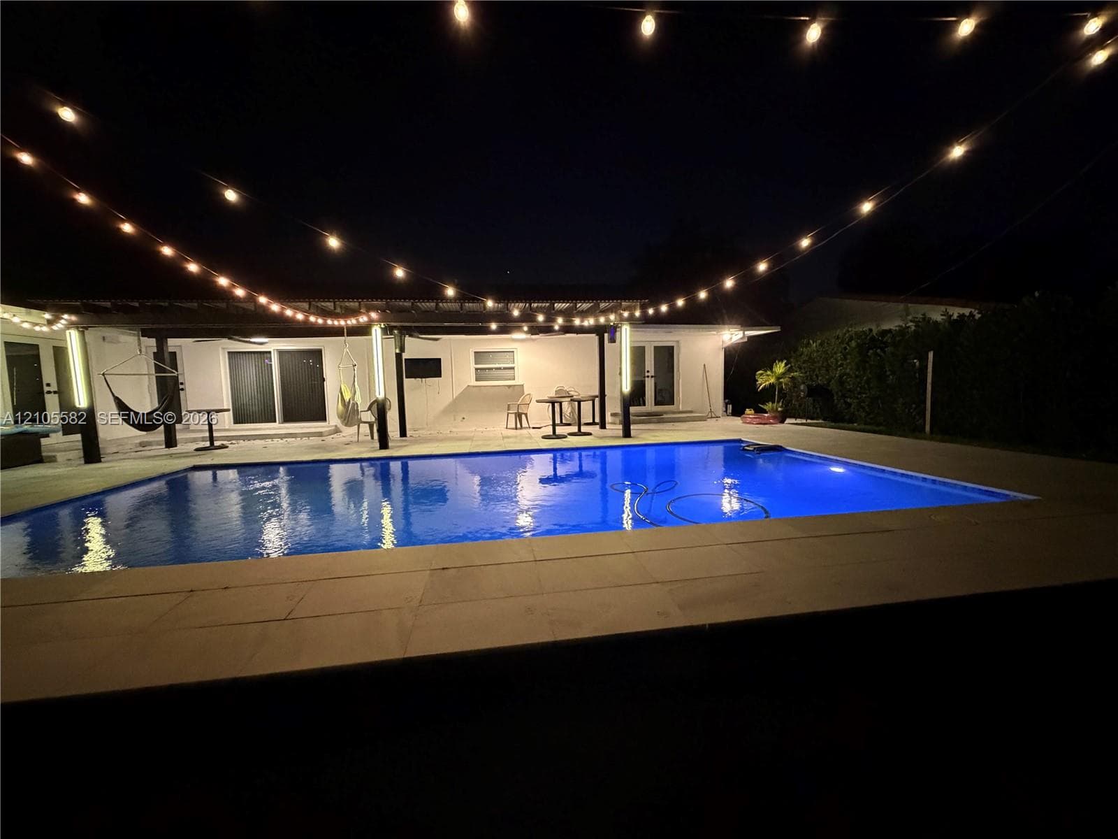 Rectangular swimming pool with light-colored coping