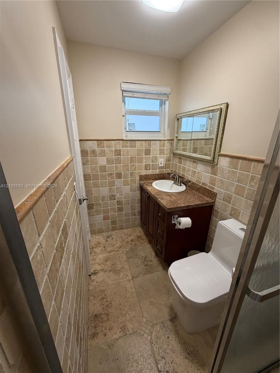 Warm-toned tiled flooring complemented by mosaic wall tiling