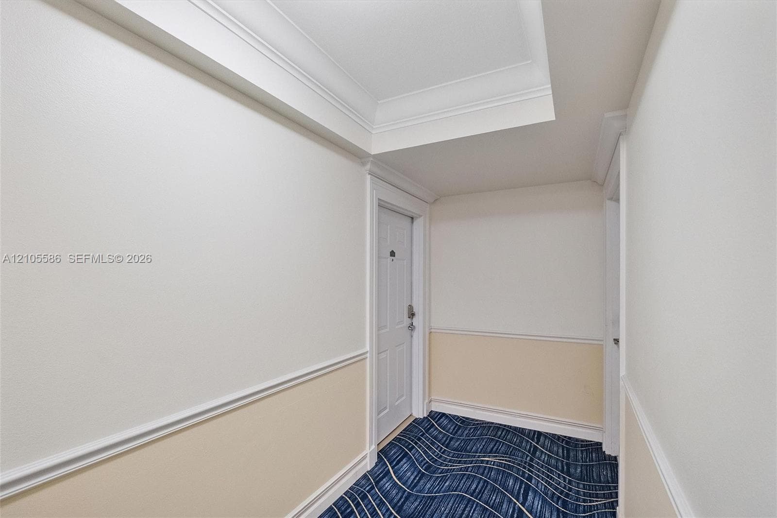 Crown molding, decorative wall trim, painted doors, and patterned carpeting