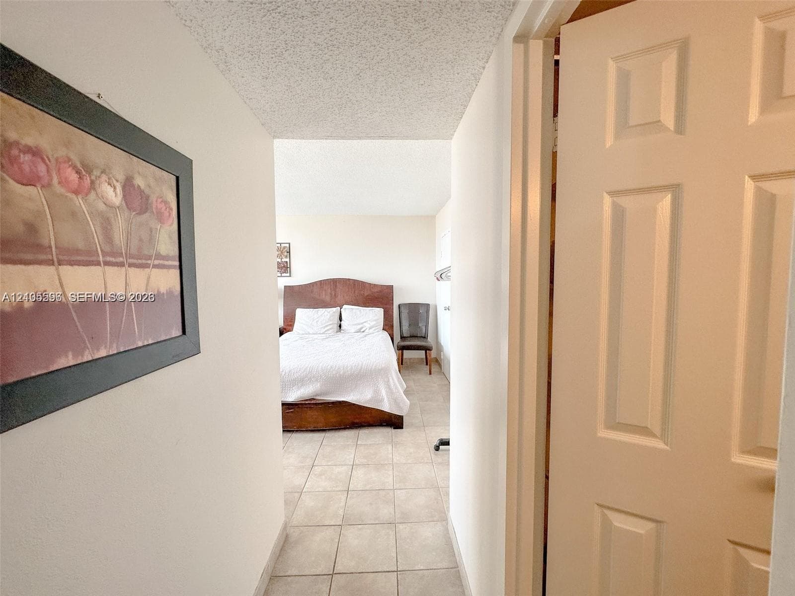 Ceramic tile flooring throughout, white interior doors, and neutral wall tones