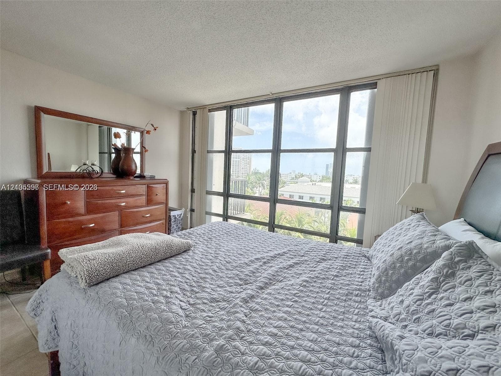 Floor-to-ceiling windows featuring grid-style frames and tile flooring