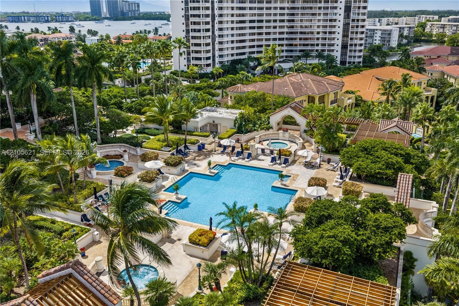 Common area amenities including a swimming pool, multiple spas, landscaped grounds, and wood-slat pergolas