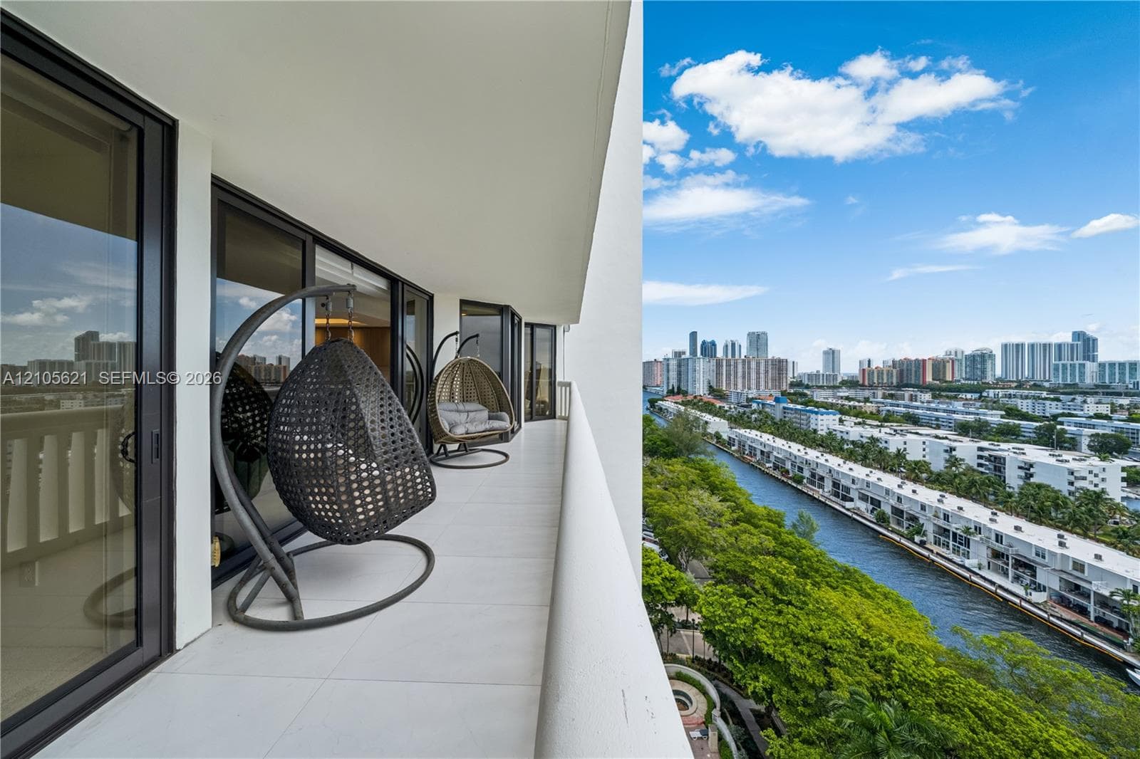 Covered balcony featuring tile flooring and floor-to-ceiling glass doors