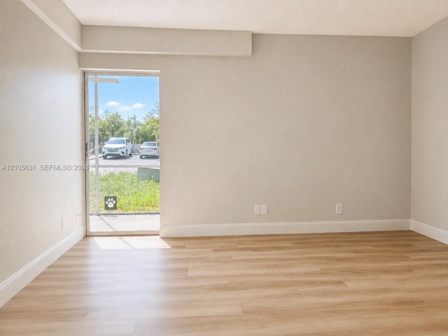 Neutral wall finishes, wood-finish flooring, and sliding glass exterior door
