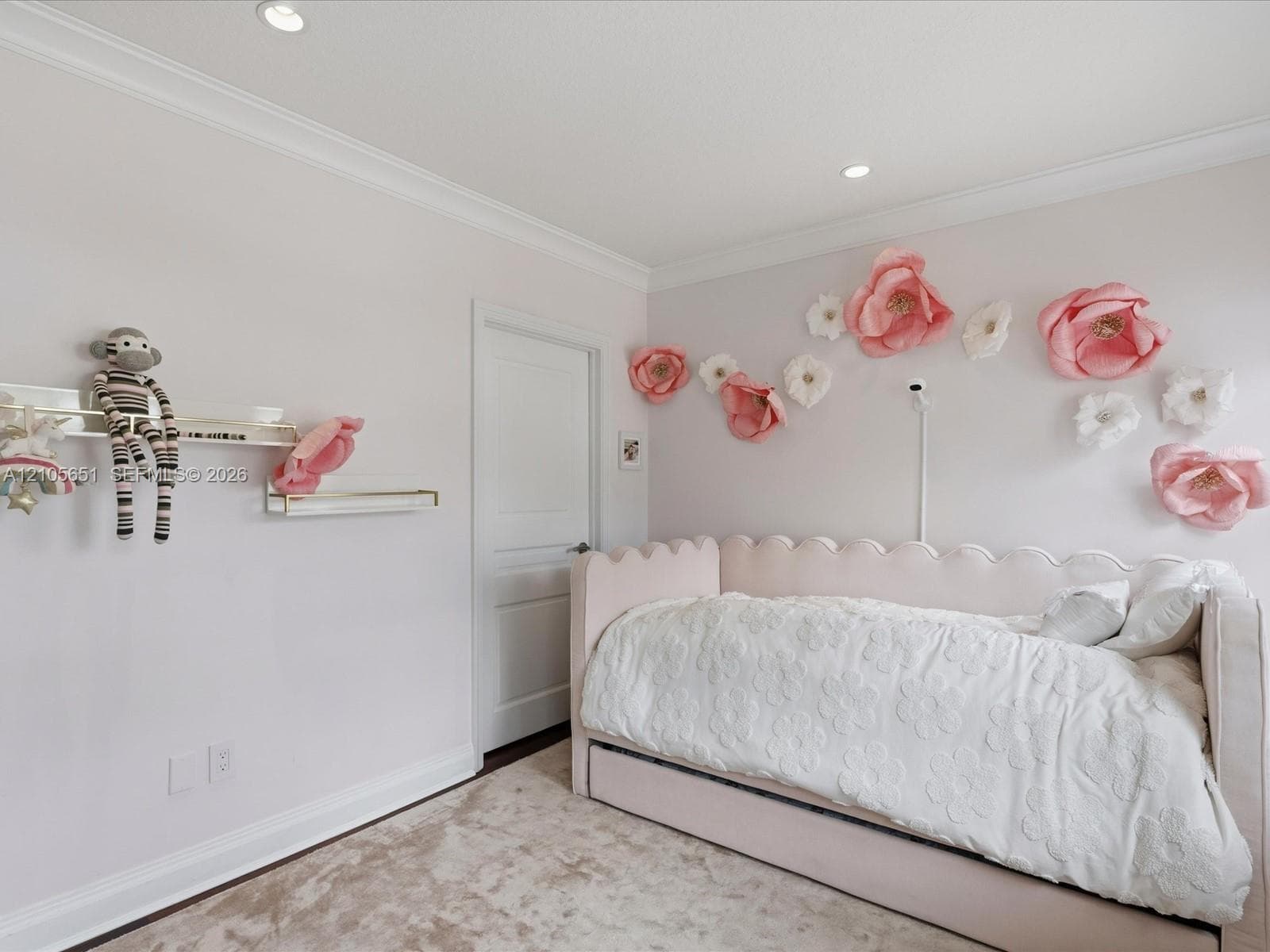 Room featuring crown molding, recessed lighting, and two wall-mounted floating shelves