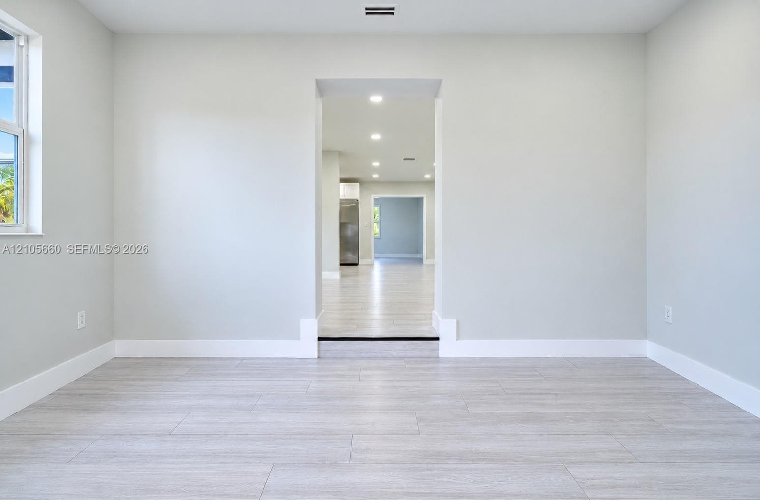 Interior space featuring wood-finish flooring, neutral wall tones, and recessed lighting