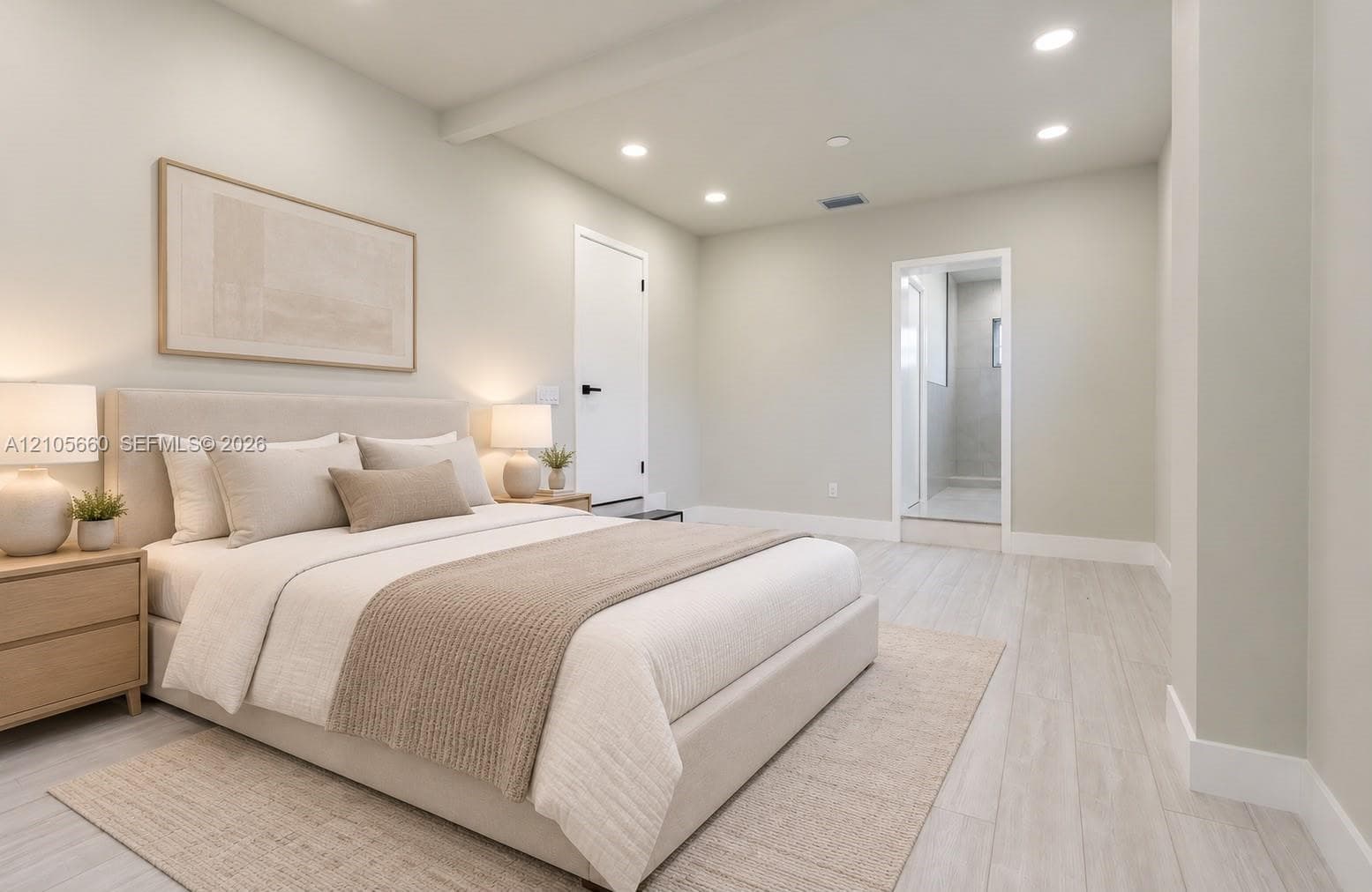 Neutral-toned interior featuring wood-finish flooring, recessed lighting, and a doorway opening to a tiled enclosure