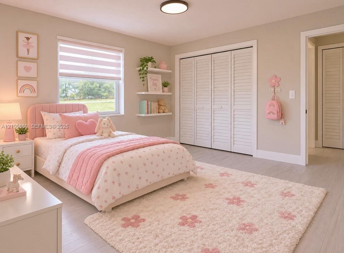Neutral walls paired with light-toned wood-finish flooring, featuring three built-in wall shelves, white louvered closet doors, and a double-pane window with a horizontal shade