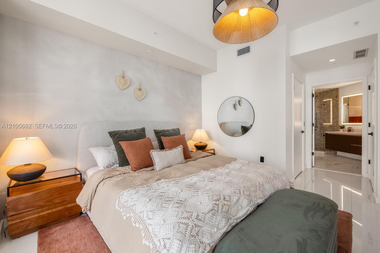 High-gloss flooring, recessed ceiling lighting, a textured accent wall, and a drum-style pendant light fixture