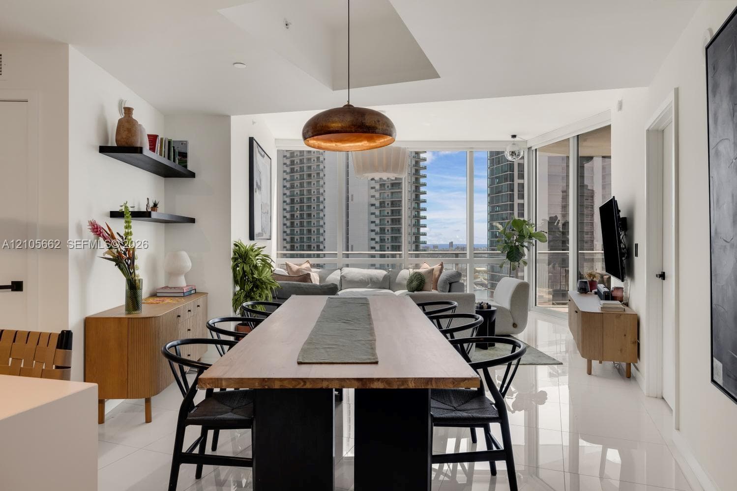 Open-concept space featuring floor-to-ceiling windows, polished tile flooring, recessed ceiling lighting, and matte black wall-mounted shelving