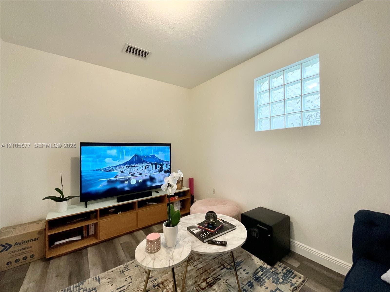 Interior space featuring wood-finish flooring and a glass block window