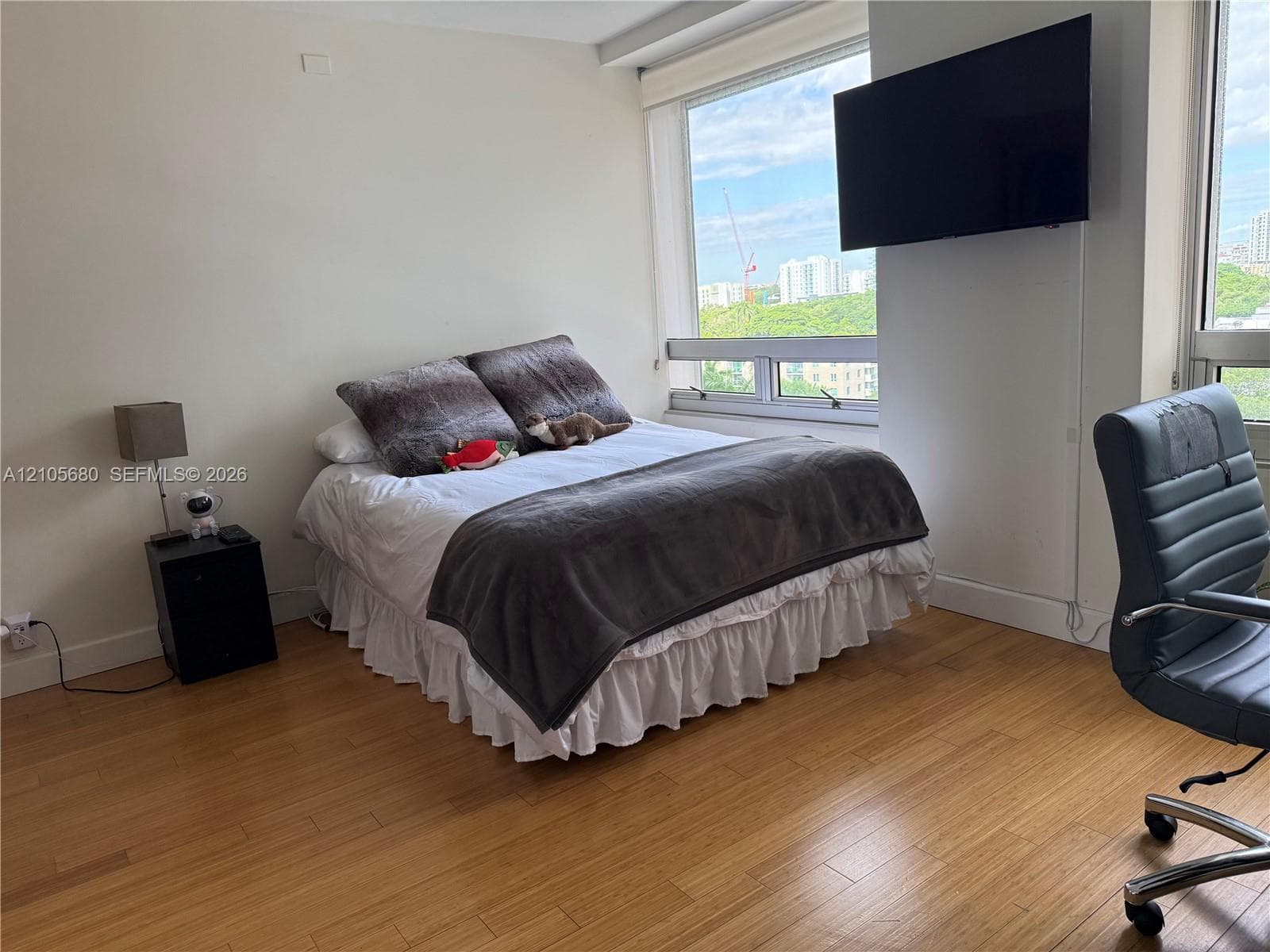 Expansive window featuring water scenery, wood-finish flooring, and light-toned wall finishes