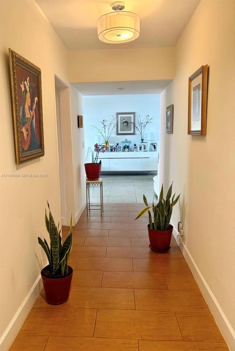 Entry hall featuring large-format tile flooring and a drum-style ceiling light fixture