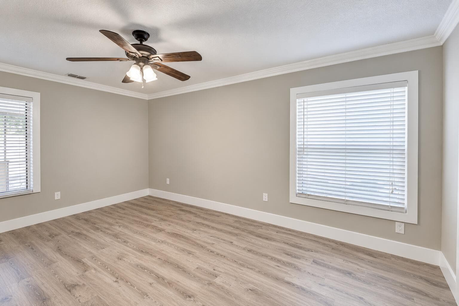 Empty Neutral-Toned Room with Ceiling Fa